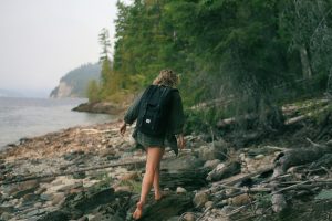 woman walking on the lake shore